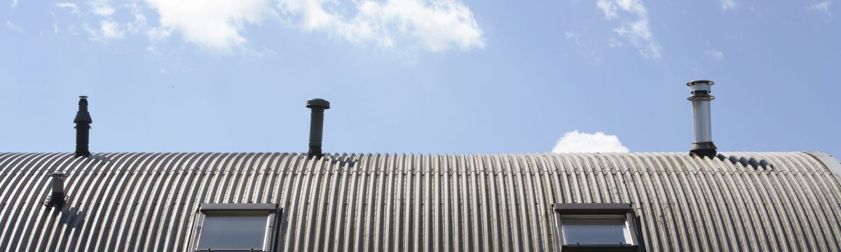 Metal roof with  windows and chimneys